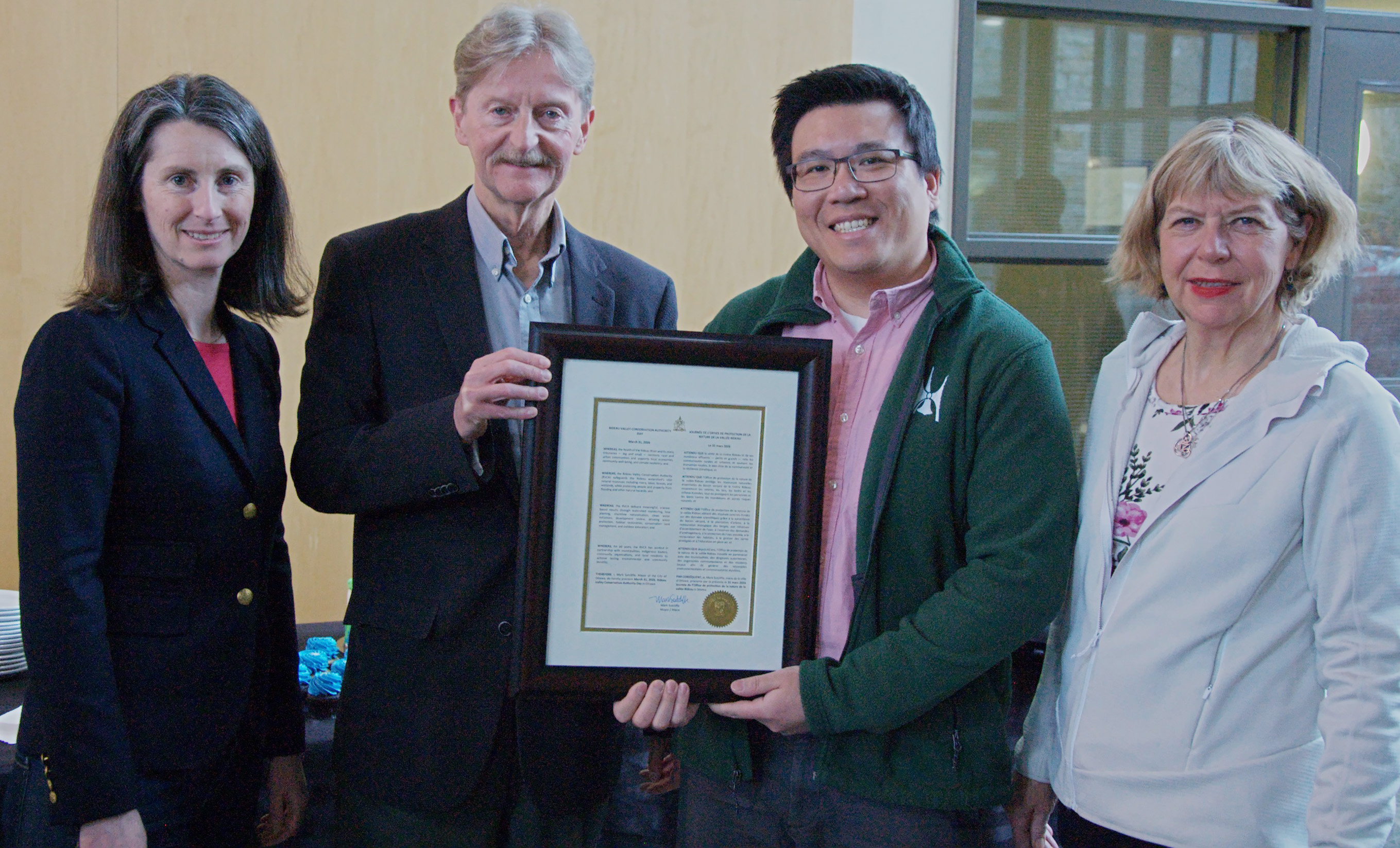 Councillor Wilson Lo presents a framed proclamation to Gary Waterfield
