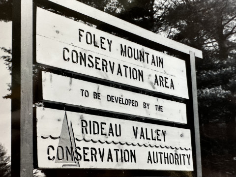 A black and white photo shows the original Foley Mountain entrance sign from the early 1970s.