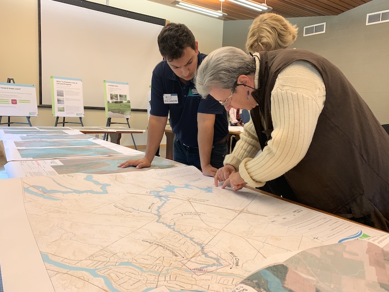 RVCA staff and client look at a map together